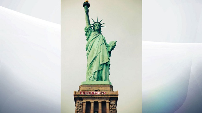 `Refugees Welcome` sign unfurled by activists on Statue Of Liberty in New York